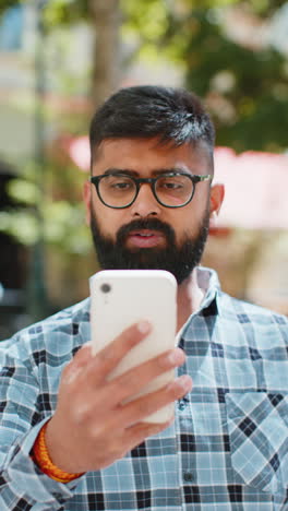 Excited-happy-Indian-young-man-use-smartphone-celebrating-win-good-message-news-in-city-street