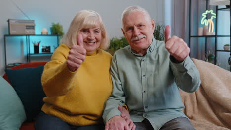 Happy-senior-family-looking-approvingly-at-camera-showing-thumbs-up,-like-positive-sign,-good-news
