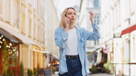 Woman-tourist-having-remote-conversation-communicate-speaking-by-smartphone-with-friend-good-news