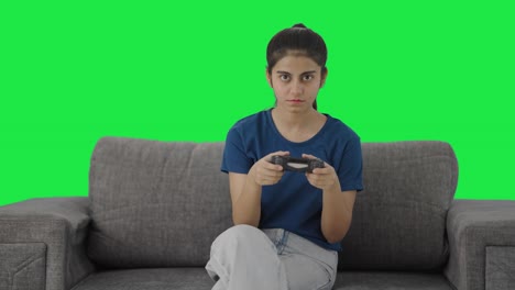 Bored-Indian-teenage-girl-playing-video-games-Green-screen