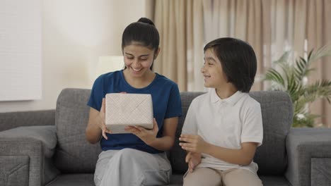 Indian-boy-giving-gift-to-his-sister