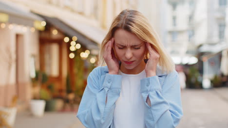 Displeased-exhausted-woman-rubbing-temples-to-cure-headache-problem-suffering-from-tension-migraine