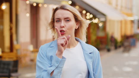 Woman-lady-presses-index-finger-to-lips-makes-silence-hush-gesture-sign-do-not-tells-gossip-secret