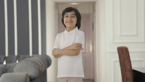 Portrait-of-Happy-Indian-boy-standing-crossed-hands