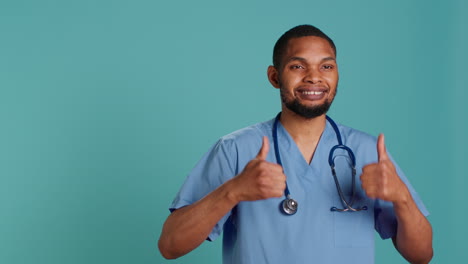 Cheerful-male-nurse-showing-thumbs-up-signs
