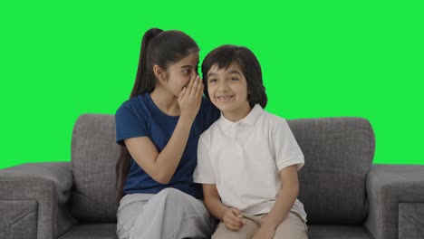 Indian-sister-telling-a-secret-to-her-brother-Green-screen