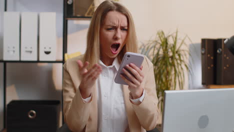 Young-office-business-woman-use-smartphone-surprised-by-bad-news,-fortune-loss,-fail-lottery-results