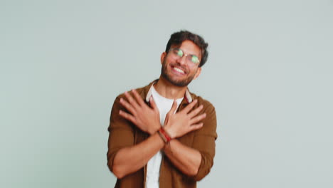 Happy-young-Indian-man-listening-music-dancing-disco-having-fun-relaxing-on-party-making-funny-moves