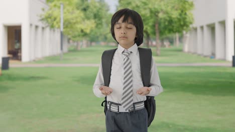 Indian-school-boy-doing-breathe-in-breathe-out-exercise