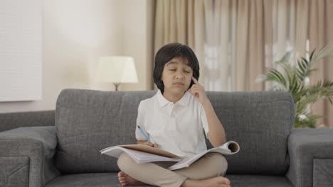 Confused-Indian-boy-reading-and-studying