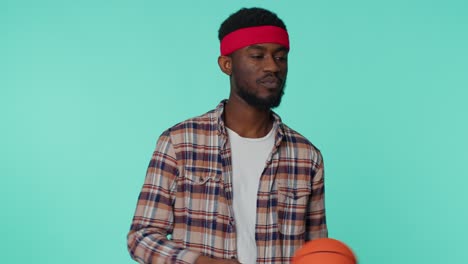 Bearded-happy-african-american-young-man-basketball-sport-fan-holding-ball-looking-at-camera