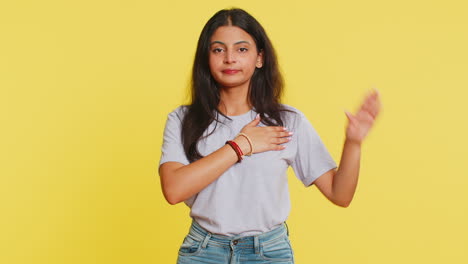 Indian-woman-raising-hand-to-take-oath-promising-to-be-honest,-to-tell-truth-keeping-hand-on-chest