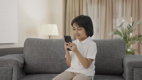 Indian-boy-chatting-with-someone-on-phone