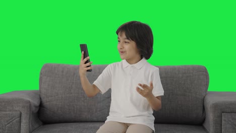 Happy-Indian-boy-talking-on-video-call-Green-screen