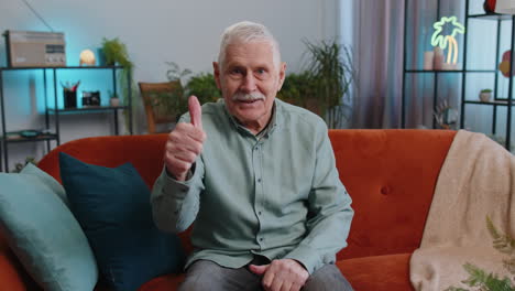 Happy-grandfather-man-looking-approvingly-at-camera-showing-thumbs-up,-like-positive-sign,-good-news