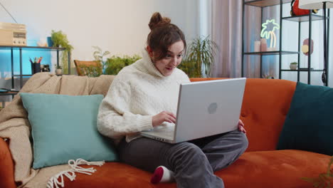 Amazed-young-woman-use-laptop-computer,-receive-good-news-message,-shocked-by-victory,-celebrate-win