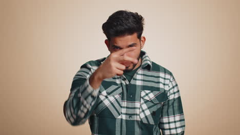 Indian-man-pointing-at-his-eyes-and-camera-show-I-am-watching-you-gesture-spying-watching-on-someone