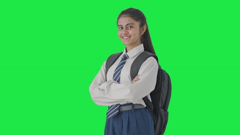 Portrait-of-Happy-Indian-school-girl-standing-crossed-hands-Green-screen