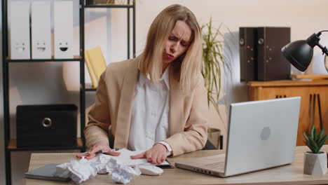 Angry-furious-woman-working-at-home-office-throwing-crumpled-paper,-having-nervous-breakdown-at-work