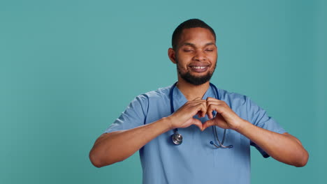 Portrait-of-cheerful-healthcare-professional-doing-heart-symbol-shape