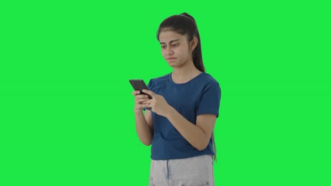 Angry-Indian-teenage-girl-texting-someone-Green-screen