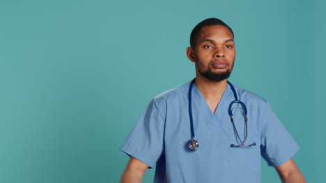 Sad-male-nurse-showing-thumbs-down-signs-while-at-work