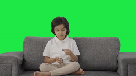 Happy-Indian-boy-counting-money-coins-Green-screen