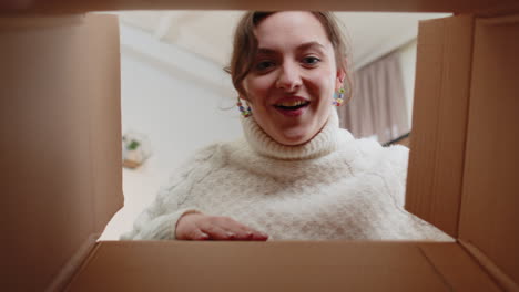 Happy-young-woman-shopper-unpacking-cardboard-box-delivery-parcel-online-shopping-purchase-at-home