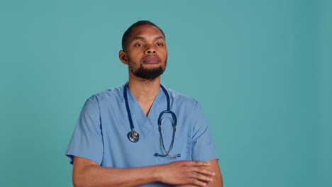 Portrait-of-joyous-caretaker-standing-with-arms-folded,-having-positive-emotion