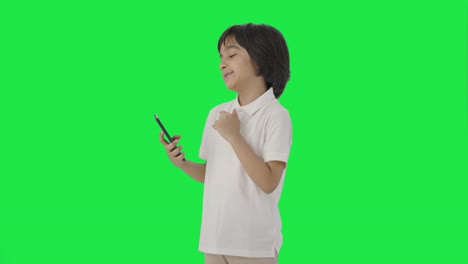 Lazy-Indian-boy-scrolling-phone-Green-screen