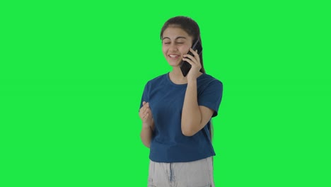 Happy-and-excited-Indian-teenage-girl-talking-to-someone-on-call-Green-screen