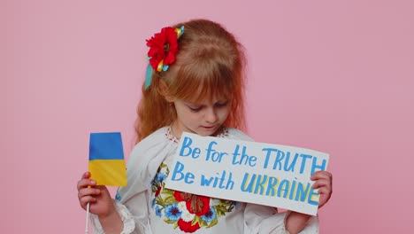 Upset-toddler-Ukrainian-girl-protesting-war-conflict-raises-inscription-massage-Hands-Off-Ukraine