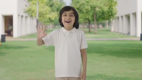 Happy-Indian-boy-saying-Hi-to-the-camera-in-park