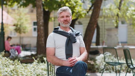 Mature-man-tourist-smiling-at-camera-waving-hands-gesturing-invitation-hello-hi-greeting-goodbye