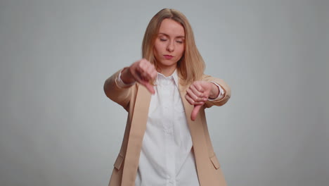 Upset-business-woman-girl-in-suit-showing-thumbs-down-sign-gesture,-disapproval-dissatisfied-dislike