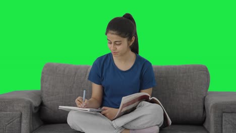 Happy-Indian-teenage-girl-preparing-for-exams-Green-screen