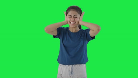 Frustrated-Indian-teenage-girl-covering-her-ears-Green-screen