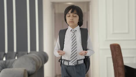 Indian-school-boy-doing-breathe-in-breathe-out-exercise