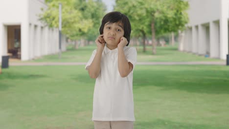 Guilty-Indian-boy-saying-sorry-and-apologizing-in-park