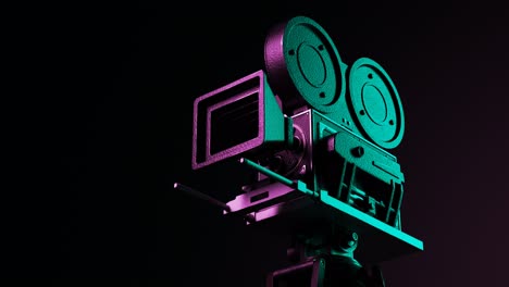 Old,-retro-vintage-film-camera-on-a-pitch-black-background.-Colorful-green-and-pink-lights-illuminate-a-reel-case-shoving-hollywoods-cinematographic-equipment.-Camera-heading-around-the-equipment.