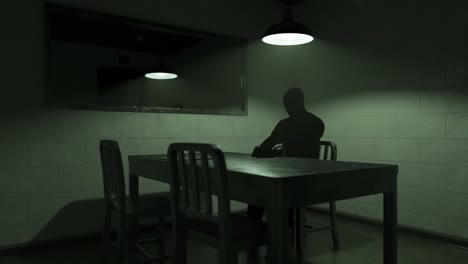 Timelapse-animation-of-an-interrogation-room-with-dark-silhouette-of-a-handcuffed-man-waiting-for-an-interview.-Investigation-of-a-crime.-Relation-of-the-own-version-of-the-sequence-of-events.