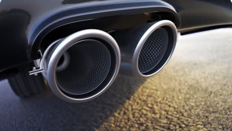 Sports-car-chrome-exhaust-in-close-up-symbolizing-automobile-performance,-power,-durability-and-carbon-dioxide-pollution-levels.-Vehicle-standing-on-an-asphalt-road-during-sunset-on-a-clear-weather.