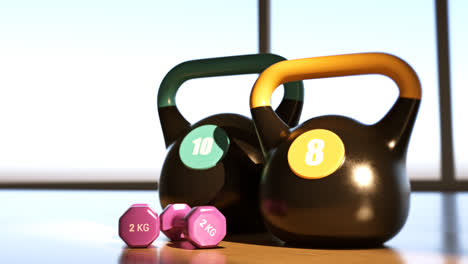 A-Pair-Of-Black-Kettlebells-And-Pink-Dumbbell-On-Hardwood-Floor.-Pastel-gym-equipment-for-fitness-exercises,-aerobics-workout.-Concept-of-sport,-health,-bodybuilding,-weightlifting,-crossfit.