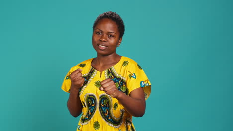 Strong-rebel-woman-posing-with-clenched-fists-in-studio