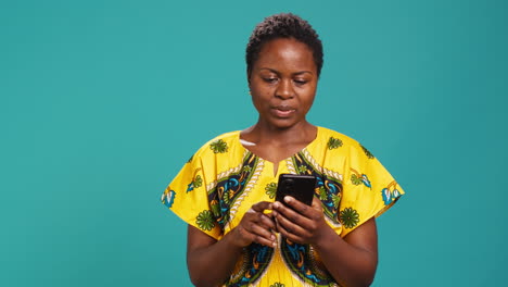 Cheerful-excited-woman-reading-very-good-news-on-her-mobile-phone