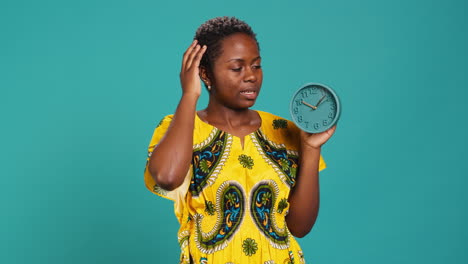 Young-woman-checking-the-time-on-a-clock-and-running-late