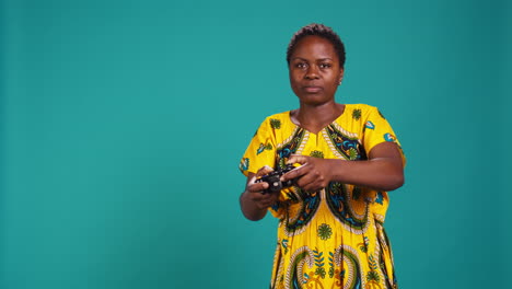 Optimistic-confident-woman-playing-videogames-on-console-in-studio