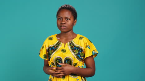 Uncertain-woman-acting-confused-and-raising-shoulders-in-studio