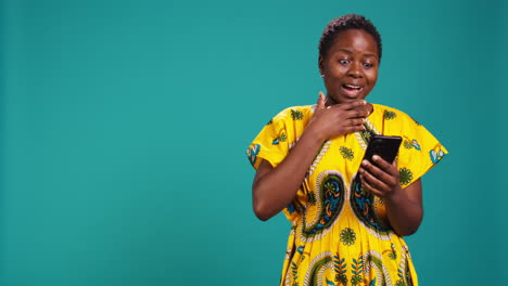 Cheerful-excited-woman-reading-very-good-news-on-her-mobile-phone