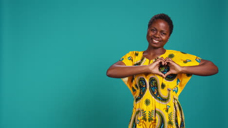 Natural-feminine-woman-showing-a-sweet-heart-shape-symbol-in-studio